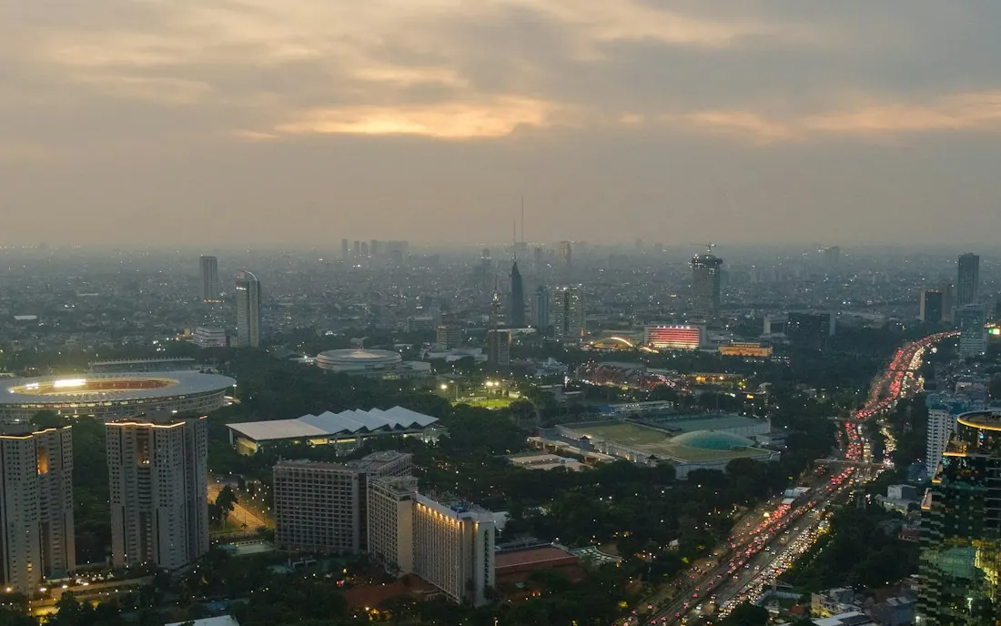 Aerial view of an urban freeway network at dusk